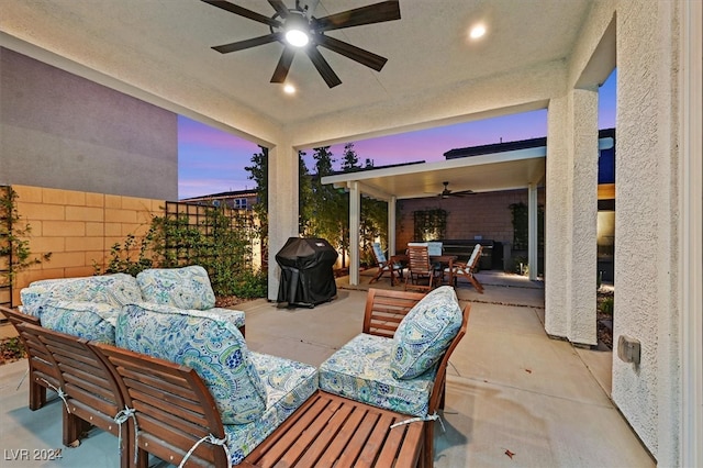 patio terrace at dusk featuring an outdoor living space, area for grilling, and ceiling fan