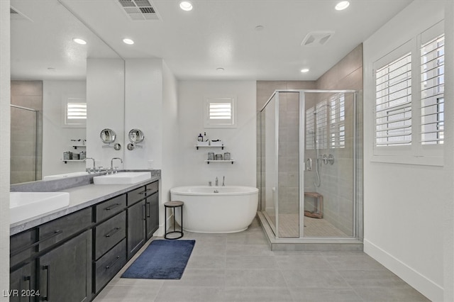 bathroom with tile patterned flooring, vanity, and separate shower and tub