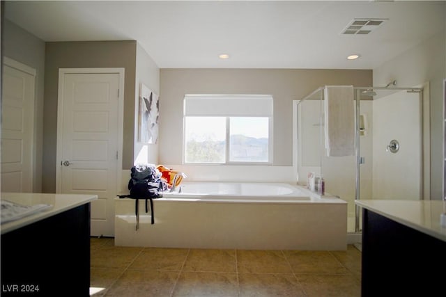 bathroom with tile patterned flooring, vanity, and shower with separate bathtub