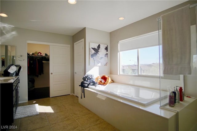 bathroom featuring a bath, vanity, and tile patterned floors