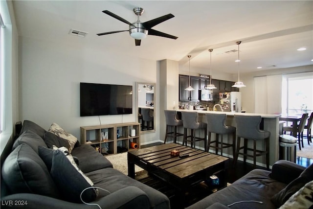 living room featuring hardwood / wood-style flooring and ceiling fan