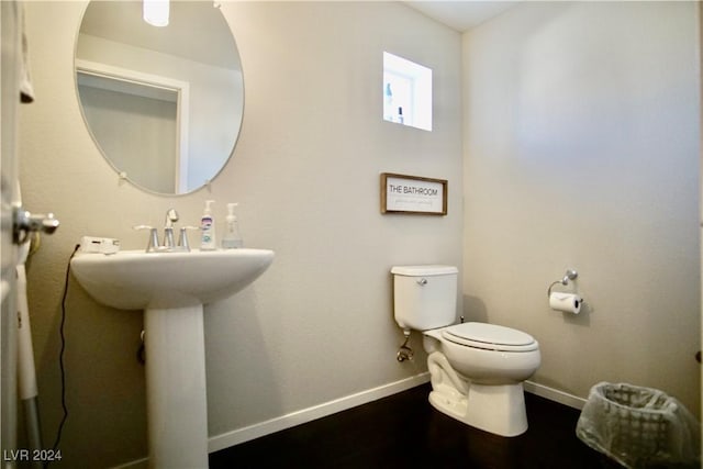 bathroom with hardwood / wood-style floors and toilet