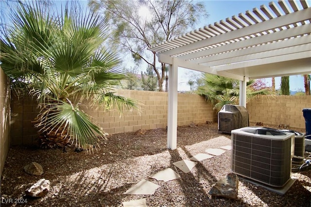 view of patio with area for grilling, a pergola, and central AC