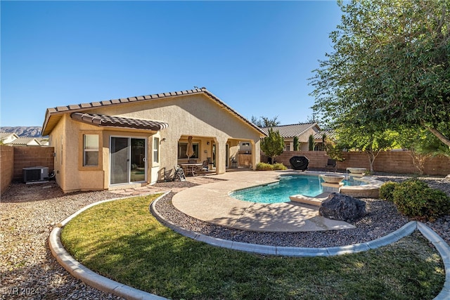 back of property with a patio, central AC unit, and a pool with hot tub