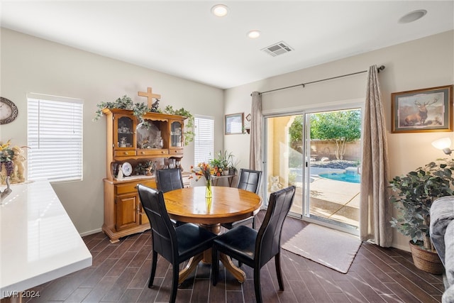 dining space with dark wood-type flooring