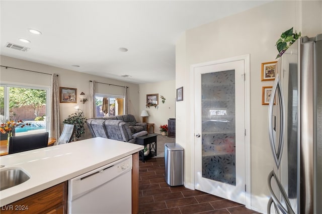 kitchen with stainless steel refrigerator, white dishwasher, and dark hardwood / wood-style floors