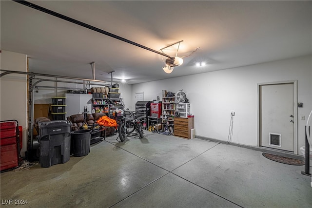 garage featuring white fridge and a garage door opener