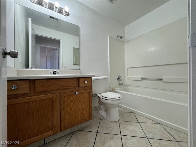 full bathroom featuring toilet, vanity,  shower combination, and tile patterned floors