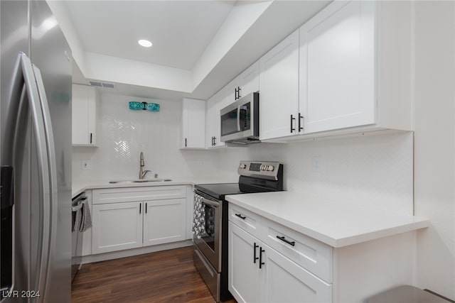 kitchen featuring dark hardwood / wood-style flooring, white cabinetry, sink, and stainless steel appliances