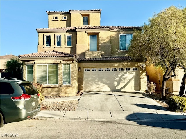 mediterranean / spanish house with a garage