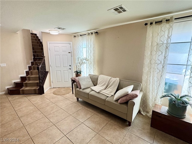 living room with light tile patterned floors and a textured ceiling