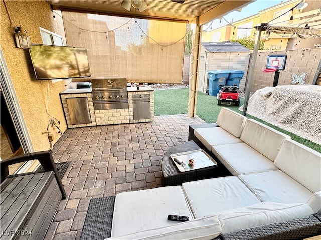 view of patio / terrace with outdoor lounge area, an outdoor kitchen, grilling area, and a storage shed