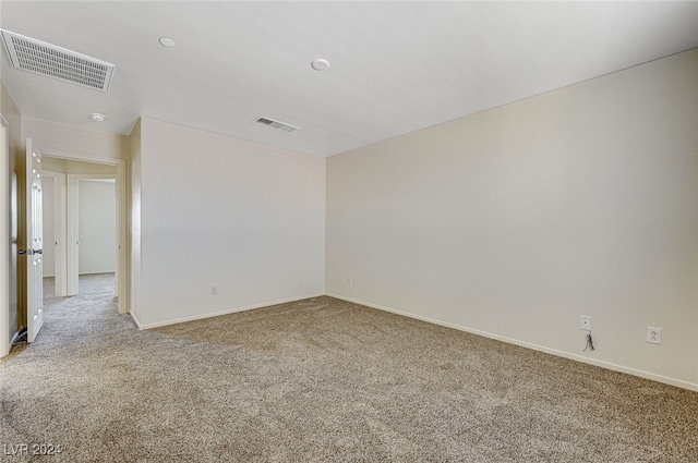 unfurnished room featuring light colored carpet