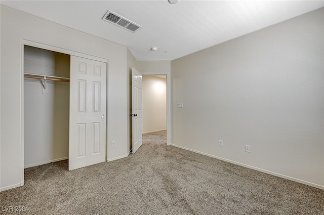 unfurnished bedroom with carpet floors and a closet