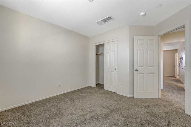 unfurnished bedroom with carpet and a closet