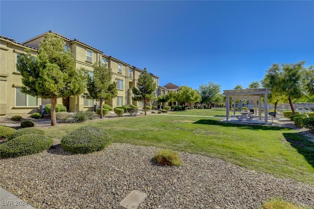 surrounding community featuring a pergola and a yard