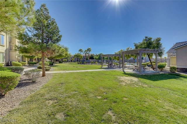 view of home's community with a pergola and a lawn