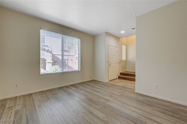 spare room with light hardwood / wood-style flooring