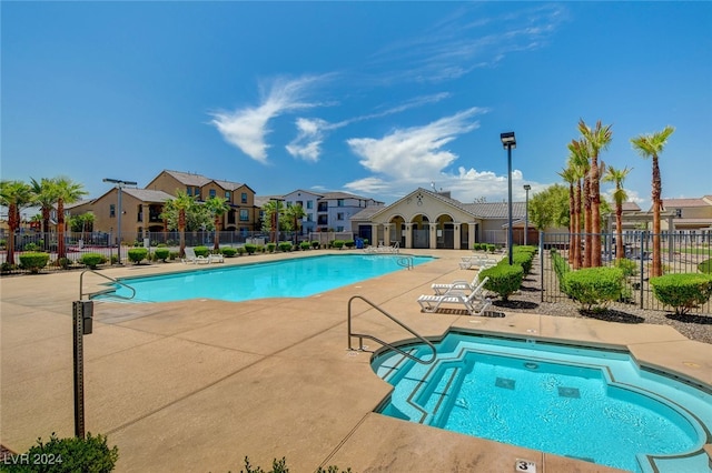 view of swimming pool with a community hot tub and a patio