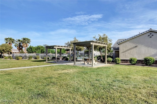 exterior space featuring a lawn, a pergola, and a patio