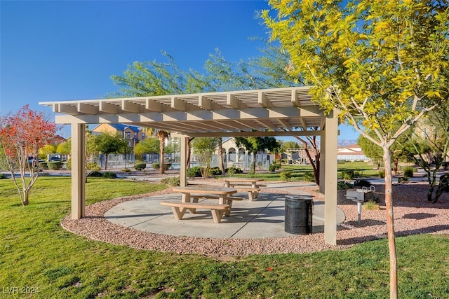 surrounding community with a lawn and a pergola