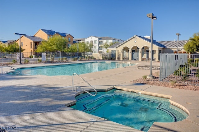 view of swimming pool with a patio area and a community hot tub