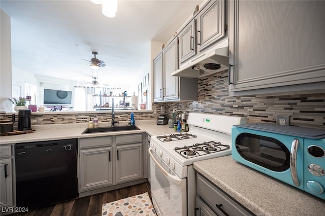 kitchen featuring gray cabinetry, gas range gas stove, sink, black dishwasher, and dark hardwood / wood-style floors