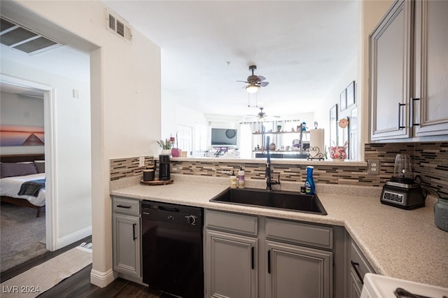 kitchen with dishwasher, sink, dark hardwood / wood-style floors, gray cabinets, and decorative backsplash