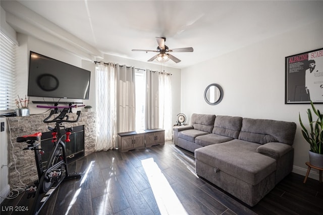 living room with ceiling fan, a fireplace, and dark hardwood / wood-style floors