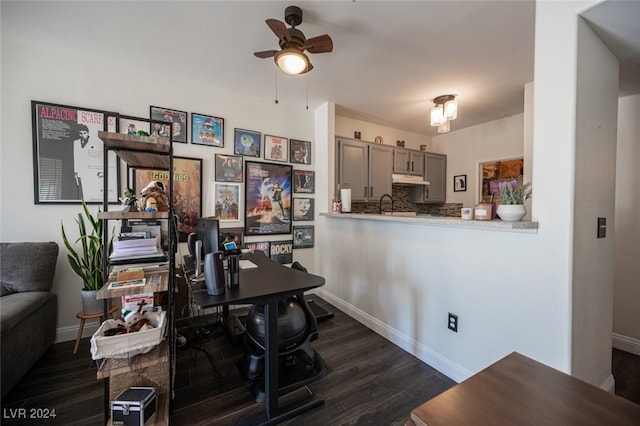 office area with ceiling fan, dark hardwood / wood-style flooring, and sink