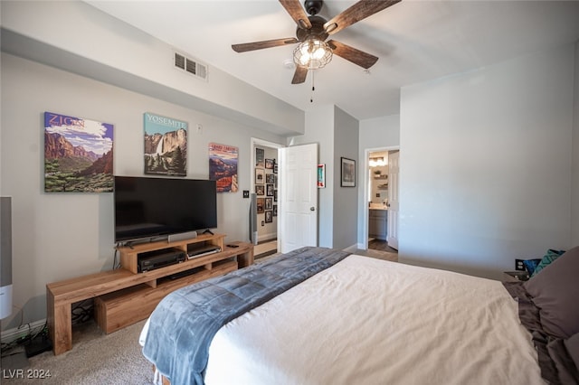 carpeted bedroom featuring ceiling fan and ensuite bathroom