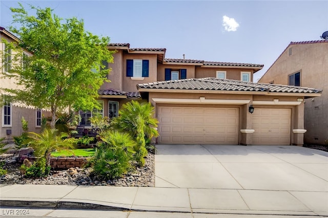 mediterranean / spanish-style home featuring a garage