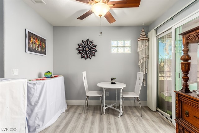dining area with ceiling fan and light hardwood / wood-style floors