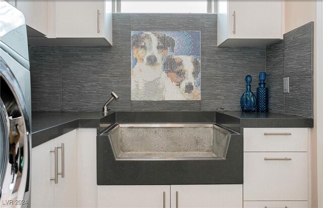 kitchen featuring backsplash, stainless steel fridge, and white cabinets