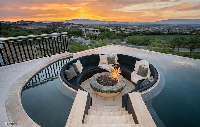 exterior space with a mountain view and a fire pit