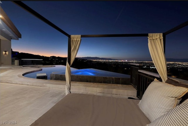 pool at dusk featuring a patio area