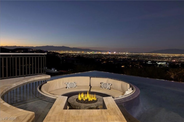 exterior space with a mountain view and an outdoor fire pit