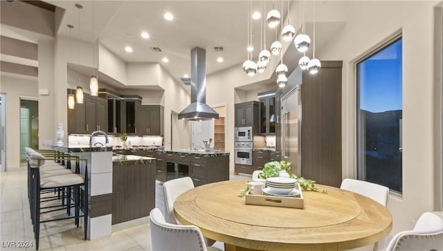 dining space with light tile patterned flooring and a high ceiling