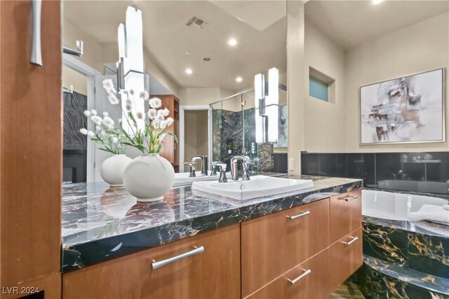 bathroom with vanity and a shower