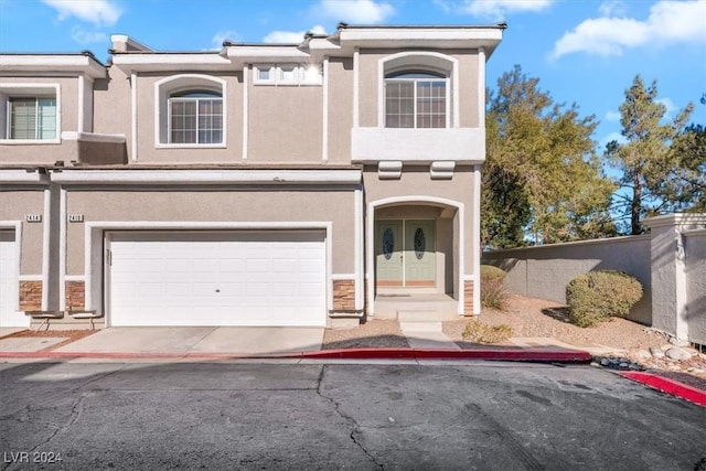 townhome / multi-family property featuring a garage