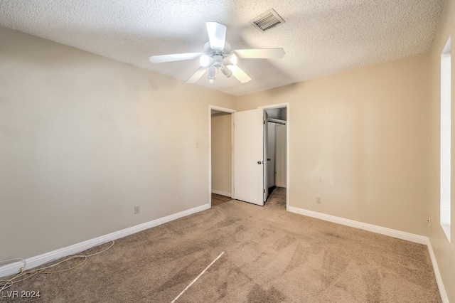 unfurnished bedroom with a textured ceiling and ceiling fan