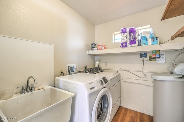 laundry room with washer and dryer, dark hardwood / wood-style floors, and sink