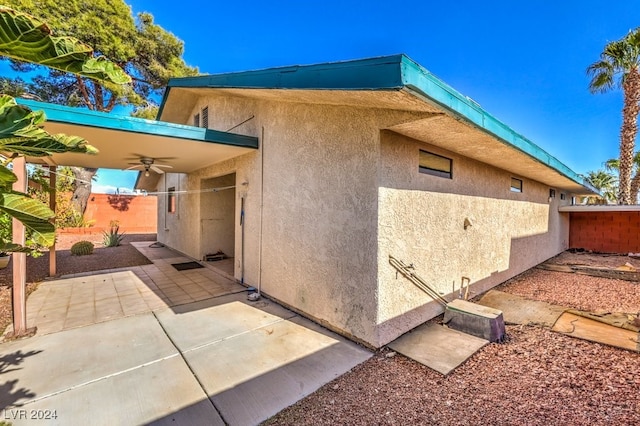 exterior space with ceiling fan and a patio area