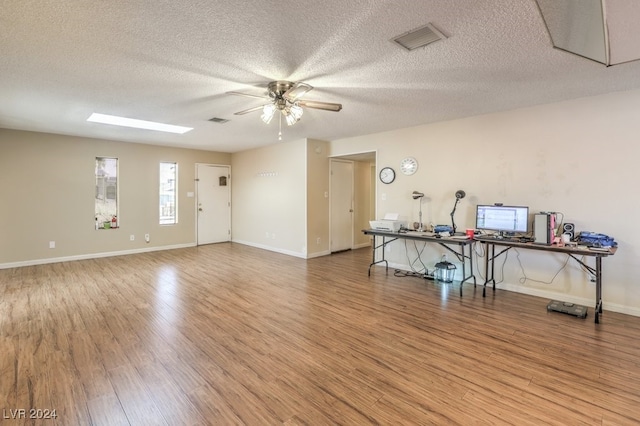 spare room featuring ceiling fan, wood-type flooring, and a textured ceiling