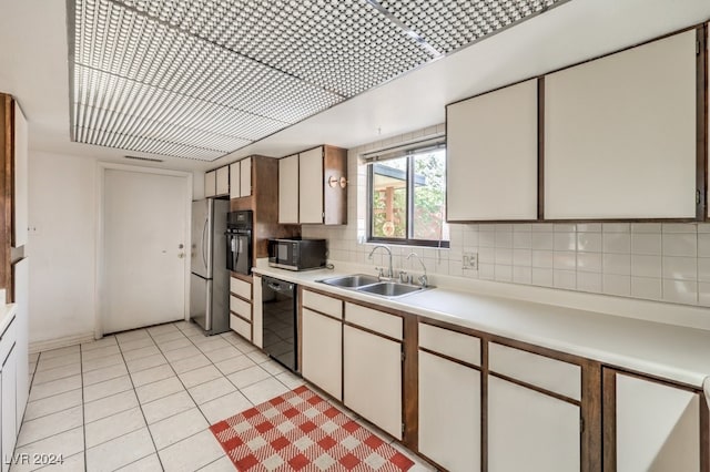 kitchen with white cabinets, sink, tasteful backsplash, and black appliances