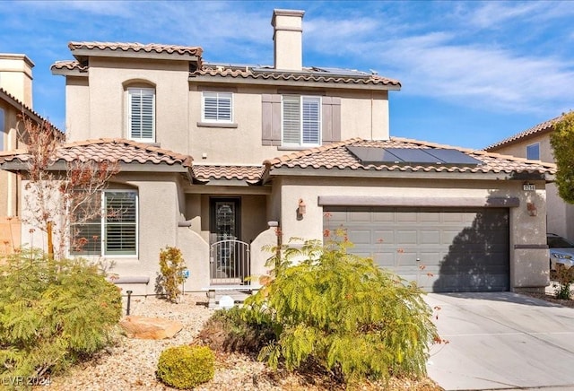 mediterranean / spanish-style house with stucco siding, concrete driveway, a chimney, and a garage