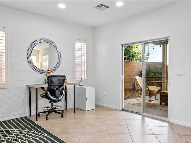 tiled office with plenty of natural light and brick wall