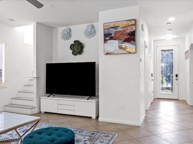 tiled living room featuring ceiling fan