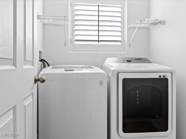 clothes washing area featuring separate washer and dryer