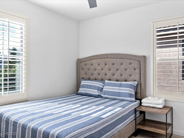 bedroom with ceiling fan and hardwood / wood-style flooring